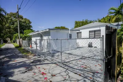 a chain link fence in front of a house at Sri House in Miami