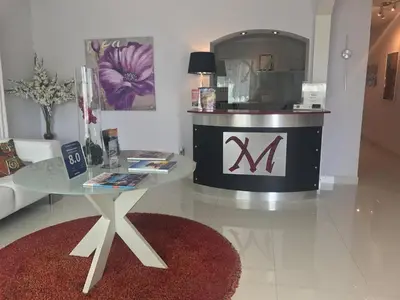 a living room with a table and a mirror at M HOTEL in Miami Beach