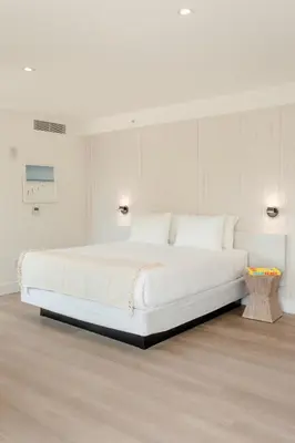 a white bedroom with a large white bed in it at Casa SOBE in Miami Beach