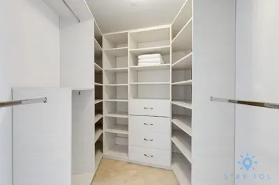 a walk in closet with white cabinets and shelves at Oceanview Luxury 3BR Sky Home Amaizing Pool in Hollywood