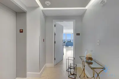 a white hallway with a glass table and a doorway at Oceanview Luxury 3BR Sky Home Amaizing Pool in Hollywood
