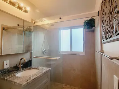 a bathroom with a sink and a glass shower at Arpe 4plex in Fort Lauderdale
