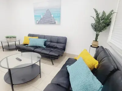 a living room with a couch and a table at Arpe 4plex in Fort Lauderdale