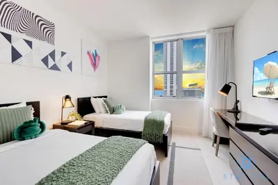 a bedroom with two beds and a window at Amazing Pools Luxury 2Br Front Ocean Bay View in Hollywood