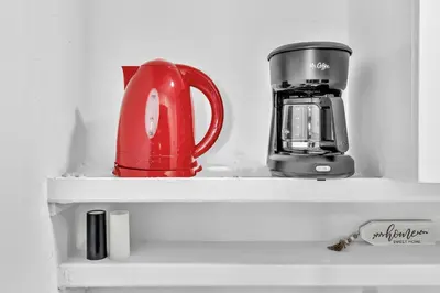 a shelf with a tea pot and a coffee maker at Hollywood Beach Getaway Executive Studio Suite in Hollywood