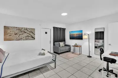 a bedroom with a bed and a couch and a desk at Hollywood Beach Getaway Executive Studio Suite in Hollywood