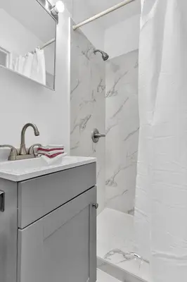 a white bathroom with a sink and a shower at Executive Studio Suite Hollywood Beach Blvd in Hollywood