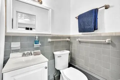 a bathroom with a toilet and a sink and a mirror at Executive Studio Hollywood Blvd & Near Beach in Hollywood