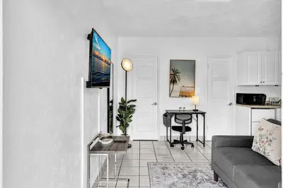 a living room with a couch and a table at Executive Studio Hollywood Blvd & Near Beach in Hollywood