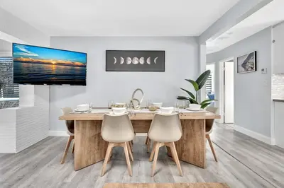 a dining room with a large wooden table and chairs at 3br Villa W Fire Pit By Hard Rock Hotel & Casino in Fort Lauderdale