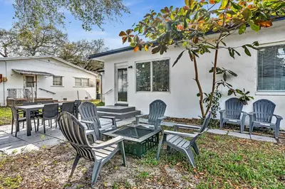 a group of chairs and a table in front of a house at 3br Villa W Fire Pit By Hard Rock Hotel & Casino in Fort Lauderdale
