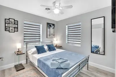 a bedroom with a bed and a ceiling fan at 3br Villa W Fire Pit By Hard Rock Hotel & Casino in Fort Lauderdale
