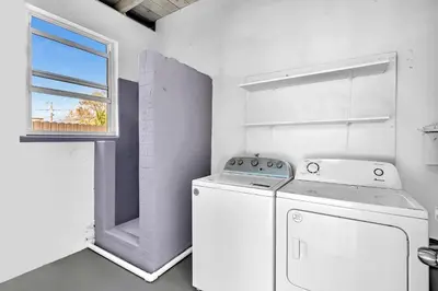 a white laundry room with a washer and a window at 3br Villa W Fire Pit By Hard Rock Hotel & Casino in Fort Lauderdale