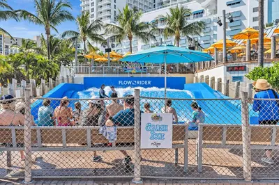 a group of people at the beach behind a fence at Young Circle & Hollywood Blvd Posh Studio Suite in Hollywood
