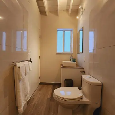 a bathroom with a white toilet and a window at Private Home Studio Central Located in Miami 1 in Opa-locka