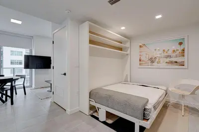 a bedroom with a bed and a dining room with a table at 1912AA DOWNTOWN MIAMI STUDIO in Miami
