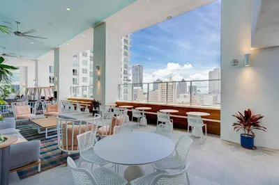 a room with tables and chairs and a large window at 1912AA DOWNTOWN MIAMI STUDIO in Miami