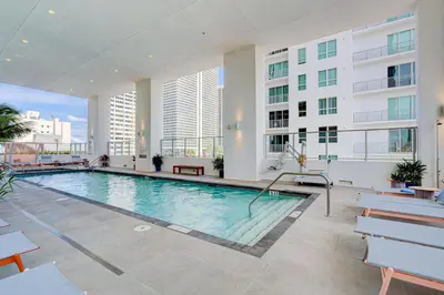 a large swimming pool in a building with buildings at 1912AA DOWNTOWN MIAMI STUDIO in Miami