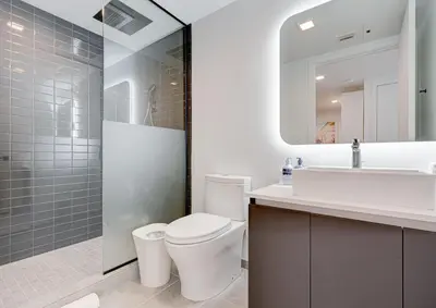 a bathroom with a toilet and a sink and a mirror at 1912AA DOWNTOWN MIAMI STUDIO in Miami