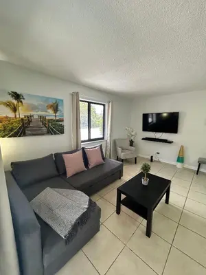 a living room with a couch and a table at Apartment in Hollywood close to shops & beach 110 in Hollywood
