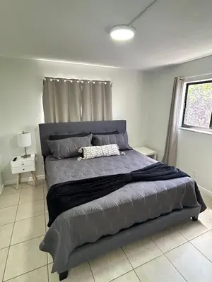 a large bed in a bedroom with a window at Apartment in Hollywood close to shops & beach 110 in Hollywood