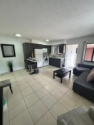 a living room with a couch and a kitchen at Apartment in Hollywood close to shops & beach 110 in Hollywood