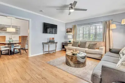 a living room with a couch and a table at Family Escape 2BR Main plus 1BR Cottage Heated Pool in Fort Lauderdale