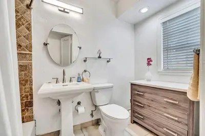 a bathroom with a sink toilet and a mirror at Family Home 2BR Heated Pool, Victoria Park in Fort Lauderdale