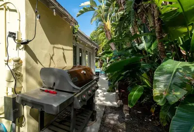 a grill outside of a house with plants at Family Home 2BR Heated Pool, Victoria Park in Fort Lauderdale