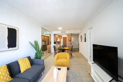 a living room with a couch and a tv at Le Cartier Apartments Sunny Isles in Sunny Isles Beach