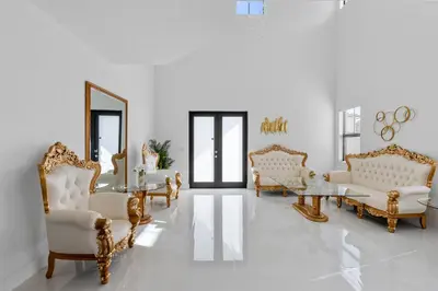 a living room with white furniture and a mirror at Miami Oasis Villa, Your Luxury Haven in Tamiami