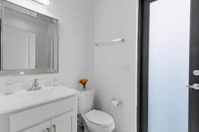 a bathroom with a toilet and a sink and a mirror at Miami Oasis Villa, Your Luxury Haven in Tamiami