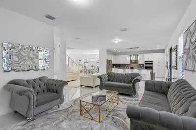 a living room with two couches and a table at Miami Oasis Villa, Your Luxury Haven in Tamiami