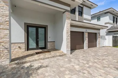 a house with a driveway in front of it at Miami Oasis Villa, Your Luxury Haven in Tamiami