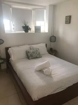 a bed with a white towel on top of it at Cozy and sweet home in Miami