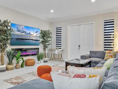 a living room with two couches and a tv at Villa ART Pool Golf Volleyball in Miami