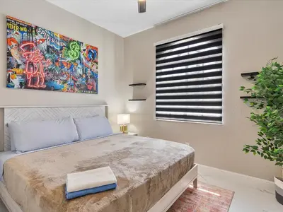 a bedroom with a large bed and a window at Villa ART Pool Golf Volleyball in Miami
