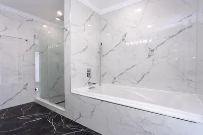 a white bathroom with a tub and a mirror at Amazing 5BR Villa Heated Pool near Hard Rock in Hollywood