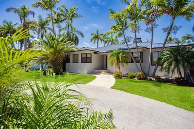 a house with palm trees and a driveway at Luxury Villa WALK 5 minutes to Hollywood Beach in Hollywood