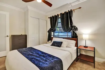 a bedroom with a large bed and a window at Magnificent Villa by Lake near Hollywood Beach in Hollywood