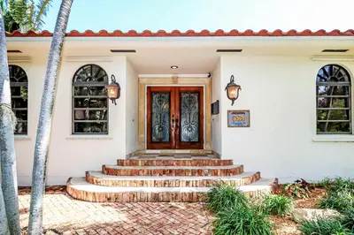 a front door of a house with stairs at Magnificent Villa by Lake near Hollywood Beach in Hollywood