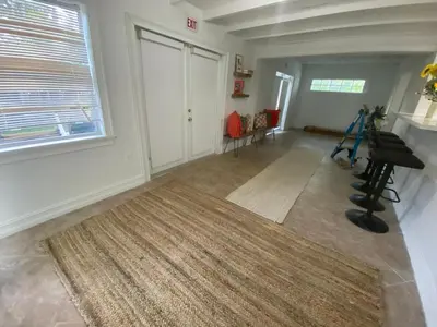 a living room with a rug and a large window at Entire home in Biscayne Park, Florida in Biscayne Park