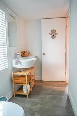 a bathroom with a sink and a door at New Nordic Touch Loft, Central Location in Miami