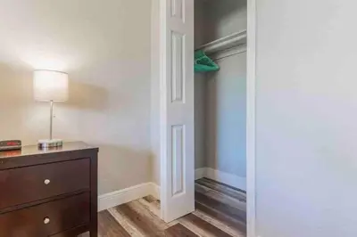 a room with a closet with a dresser and a lamp at Charming house Miami in Miami