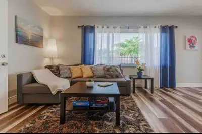 a living room with a couch and a table at Charming house Miami in Miami