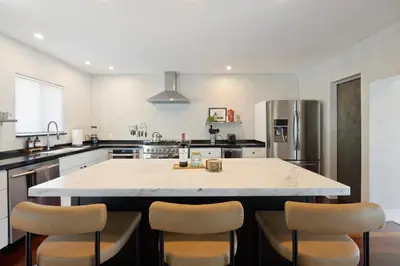 a kitchen with a large island with chairs around it at Waterfront - Kayak & Paddleboards - Firepit - Pool in Miami