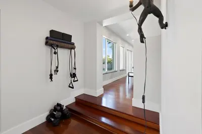 a living room with a horse hanging from a wall at Waterfront - Kayak & Paddleboards - Firepit - Pool in Miami