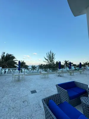 a group of chairs and tables on the beach at Marena Resort in Sunny Isles Beach