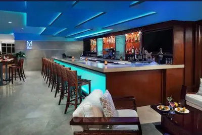 a bar in a restaurant with a bunch of chairs at Marena Resort in Sunny Isles Beach