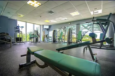 a gym with treadmills and machines in a room at Marena Resort in Sunny Isles Beach